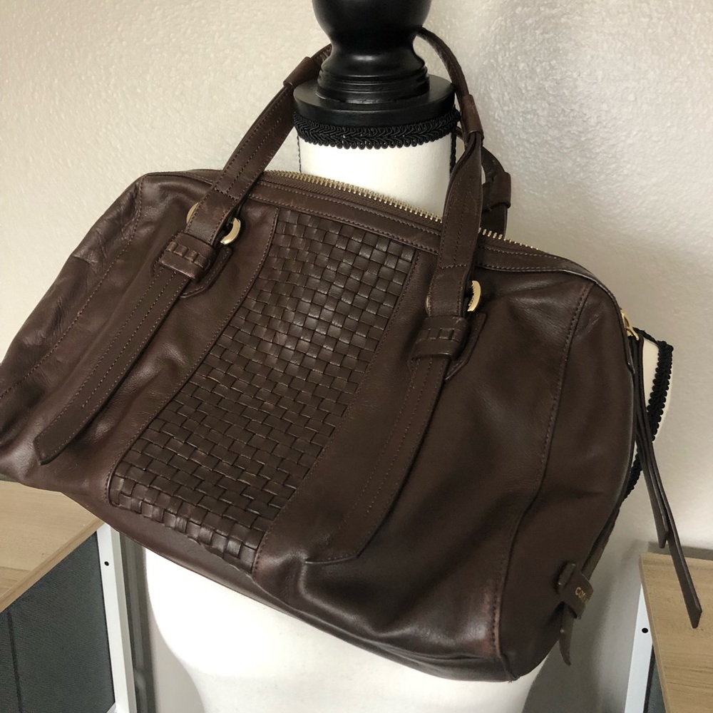 This is a 100% leather bag by Cole and comes with dust cover drawstring bag!